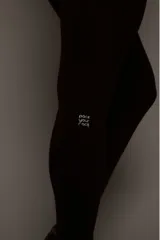 Calza deportiva de tiro alto color marrón, confeccionada en tejido técnico de alto rendimiento con compresión. Presenta bolsillos laterales funcionales y detalles reflectivos para mayor visibilidad.