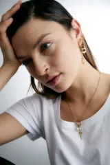 Aros dorados de acero quirúrgico hipoalergénico, con dije de chapita rectangular con bordes redondeados.