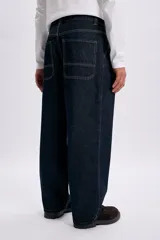 Pantalon jean de corte skater en color azul oscuro con costuras en contratapa, estilo relajado y amplio.