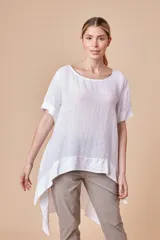 Blusa blanca de lino con corte irregular y zócalo de satén.