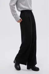 Pantalón negro de tiro alto, confeccionado en viscosa, de corte holgado y pernera ancha, con bolsillos laterales.