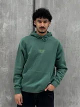 Canguro verde con capucha ajustable con cordones, bolsillo tipo canguro y logo pequeño estampado en el pecho.