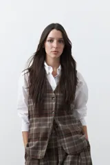 Chaleco de sastrería con estampado de cuadros en tonos tierra, diseño estructurado con escote en V y cierre frontal con botones.