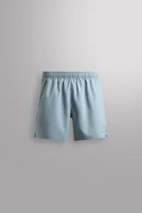 Pantalones deportivos cortos de tejido técnico ligero y elástico, con cintura elástica ajustable, bolsillos frontales y aberturas laterales en el bajo.