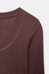 Camiseta de manga larga confeccionada en tejido rib de algodón, con escote redondo y corte regular fit.