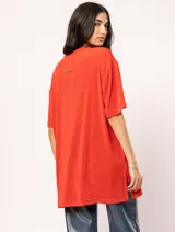 Remera blanca oversized de tela elastizada con tajos laterales y escote redondo.