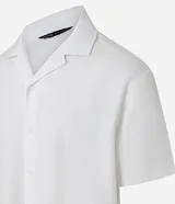 Camisa de corte boxy fit, color blanco, con cuello bowling, cierre frontal con botones y manga corta. Confeccionada en tejido de algodón con textura jacquard.