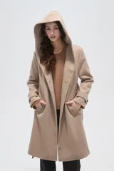 Tapado de paño color gris oscuro con solapas anchas, cierre frontal cruzado con botones y cinturón ajustable a la cintura. Posee mangas largas y bolsillos laterales.