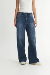 Jean azul de tiro alto, corte recto y pierna ancha.