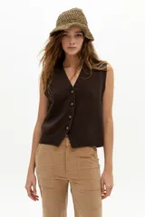 Chaleco de punto color chocolate, con escote en V profundo, cierre frontal con botones y terminaciones de rib.