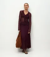 Blusa de encaje transparente color bordó, con mangas largas, escote en V con volados frontales y bajo fruncido.