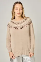 Buzo de tejido de punto color visón, con diseño de guarda andina en la zona del cuello y hombros. Presenta cuello redondo, mangas largas con puños acanalados y ruedo también acanalado.