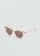 Gafas de sol con diseño redondo y montura de pasta en tono rosado traslúcido. Cuentan con cristales oscuros con protección UV categoría 3.