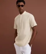Camisa Marfinno de manga corta en color beige, confeccionada en mezcla de lino y algodón. Presenta cuello padre y cierre frontal parcial con botones.