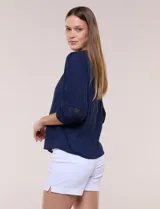 Blusa blanca de bambula con escote en V, pechera de encaje y mangas 3/4 abullonadas con detalles de puntilla.