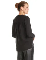 Blusa de gasa negra con diseño de doble capa, cuello a la base y escote en V pronunciado. Presenta mangas largas con puños anchos abotonados y un corte fluido.