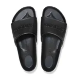 Sandalia tipo slide Birkenstock modelo Barbados, confeccionada en material EVA ligero y flexible. Presenta una banda ancha con textura hexagonal y el logo de la marca en relieve.