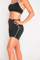 Calza corta negra de lycra suplex con cintura alta y una franja vertical blanca en el lateral.