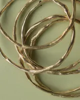 Pulsera rígida de bronce y alpaca, adaptable a muñecas de 13 a 15 cm.