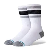 Medias Stance de caña alta color blanco, con puntera y talón en gris melange. Presentan rayas horizontales en la parte superior en tonos negro y gris, con una línea delgada en color turquesa sobre la puntera.