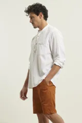 Camisa de lino color salmón con cuello mao, manga larga y bolsillo de parche en el pecho.