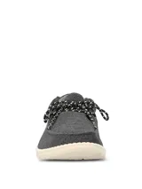 Alpargata Hush Puppies modelo Canyon, color negro con textura tejida. Presenta cordones jaspeados en blanco y negro, y suela de EVA en color crema.