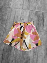 Short de fibrana con cintura elastizada y estampado floral en tonos rosa, amarillo, marrón y negro.