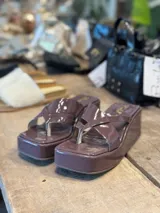 Sandalias de plataforma color uva con tiras cruzadas.