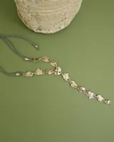 Collar artesanal compuesto por piezas irregulares de alpaca unidas por eslabones, con cordón de algodón natural regulable que permite ajustar el largo.