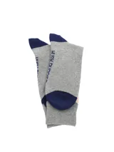 Medias de largo medio con diseño de rombos en tonos gris, azul marino y beige. Presentan puntera y talón reforzados en color azul marino.