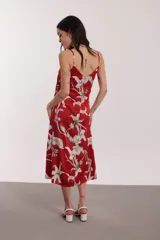 Vestido midi rojo con estampado floral blanco, de breteles finos y corte recto.