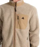 Campera de polar tipo sherpa en color beige, con cierre frontal completo, cuello alto y bolsillo en el pecho con cierre y detalle de logo triangular.