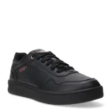 Championes Puma Court Classic de cuero sintético color negro con detalles en rosa.