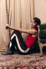 Pantalón tejido de corte recto y holgado, con cintura elástica. Presenta un diseño tricolor en los laterales con franjas verticales en negro, marrón y beige.