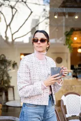 Chaqueta corta de tweed con hilos multicolores en tonos rosados, blancos y celestes, con diseño de cuello redondo sin solapas y botones delanteros.