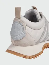 Championes Moncler modelo Pacey, color beige con detalles en gris y suela marrón con diseño dentado.