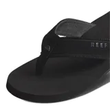 Ojotas Reef The Layback negras con plantilla texturizada y tira de tela con logo de la marca.
