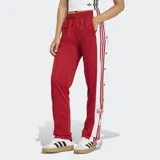Pantalon deportivo Adidas modelo Adibreak, color rojo con franjas laterales blancas y botones a presión. Presenta cintura elástica y corte holgado.