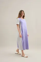 Vestido largo de lino de silueta relajada, con escote redondo, mangas cortas, bolsillos laterales y diseño bicolor con pieza central en contraste.
