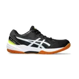 Championes Asics Gel-Task 3, diseñados para deportes de interior. Presentan un diseño en color negro con detalles en blanco y toques de amarillo neón en el talón. Cuentan con una suela de goma color caramelo, ideal para superficies de cancha, y el logo de la marca en los laterales.
