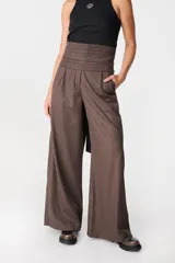 Pantalón de tiro alto con corte holgado y pierna ancha. Presenta bolsillos laterales ocultos en la costura y una faja desmontable ajustable en la cintura.