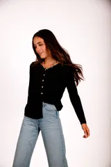 Blusa de morley elastizado color blanco, con escote en V y botones dorados.