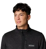 Campera polar Columbia con cierre frontal completo, cuello alto y bolsillo con cierre en el pecho. Presenta un diseño jaspeado en tonos oscuros y el logo de la marca aplicado en el pecho.