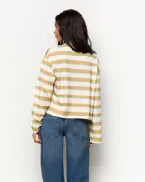 Remera polo de manga larga a rayas horizontales en tonos beige, mostaza y celeste, con cuello camisero y cartera de botones.