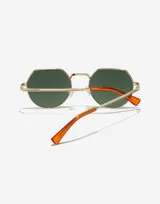 Lentes de sol con marco metálico dorado de forma octogonal, cristales polarizados en color verde oscuro y patillas con terminales en color naranja.