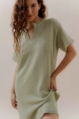 Vestido tejido color verde menta, con escote partido, mangas cortas y aberturas laterales.