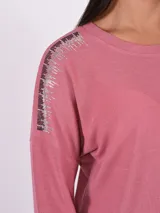 Blusa gris oscuro de manga larga con detalle de pespuntes blancos en los hombros.
