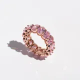 Anillo de acero con acabado en oro rosa, con cristales ovalados rosas engarzados en todo el contorno.