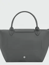Cartera de mano modelo Le Pliage One tamaño S, confeccionada en nylon negro con detalles en cuero. Presenta cierre superior con solapa y botón a presión característico de la marca.
