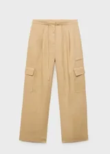 Pantalon cargo de lino color beige, con tiro medio, cintura elástica con lazo ajustable, bolsillos de parche con solapa en los laterales y corte recto.